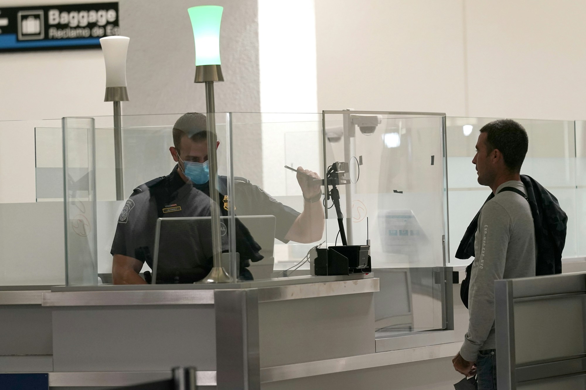 International passengers arrive at Miami international Airport where they are screened by U.S. Customs and Border Protection (CBP) using facial biometrics to automate manual document checks required for admission into the U.S. Friday, Nov. 20, 2020, in Miami. Miami International Airport is the latest airport to provide Simplified Arrival airport-wide. (AP Photo/Lynne Sladky)